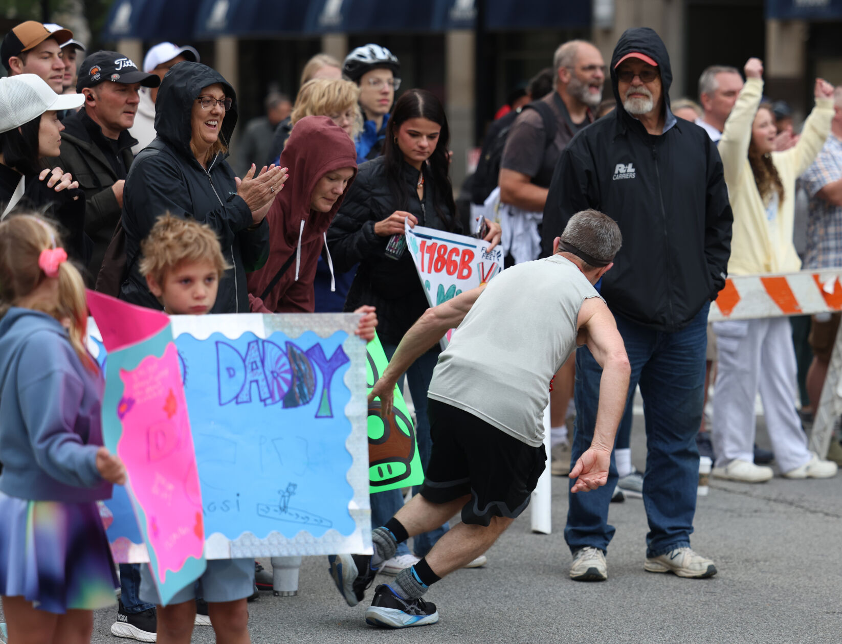 Runners touches a sign on Broadway.JPG